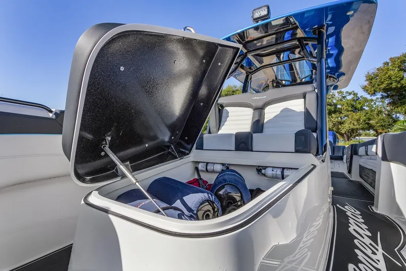 Slide: The Image of 2023 Renegade 38 Open boat with open storage compartment, showcasing interior seating and gear. - 34