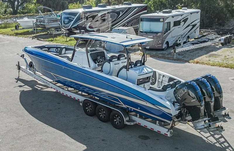 Slide: The Image of 2023 Renegade 38 Open boat with triple engines on a trailer. - 39