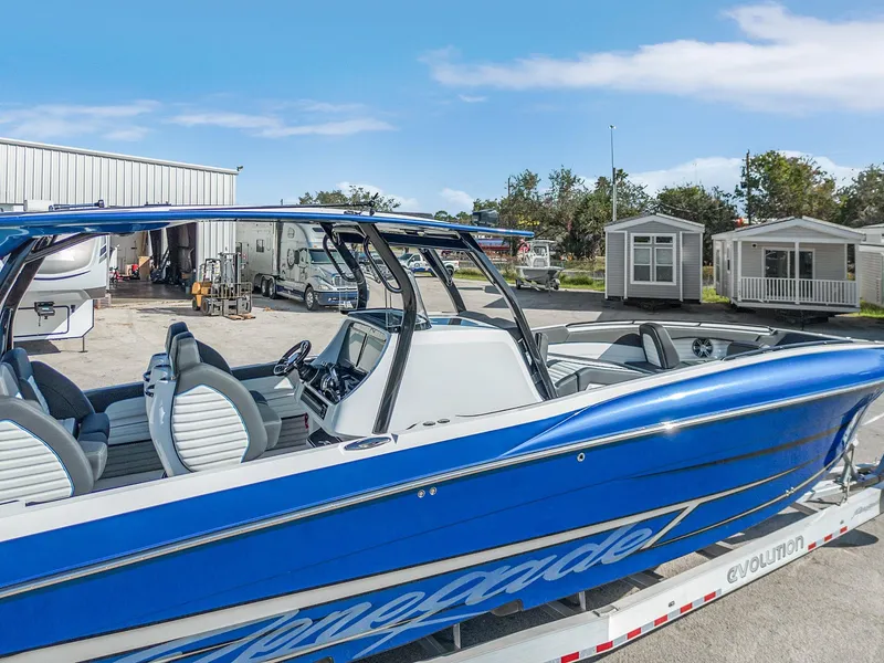 Slide: The Image of 2023 Renegade 38 Open boat, blue exterior, parked outdoors near buildings. - 42