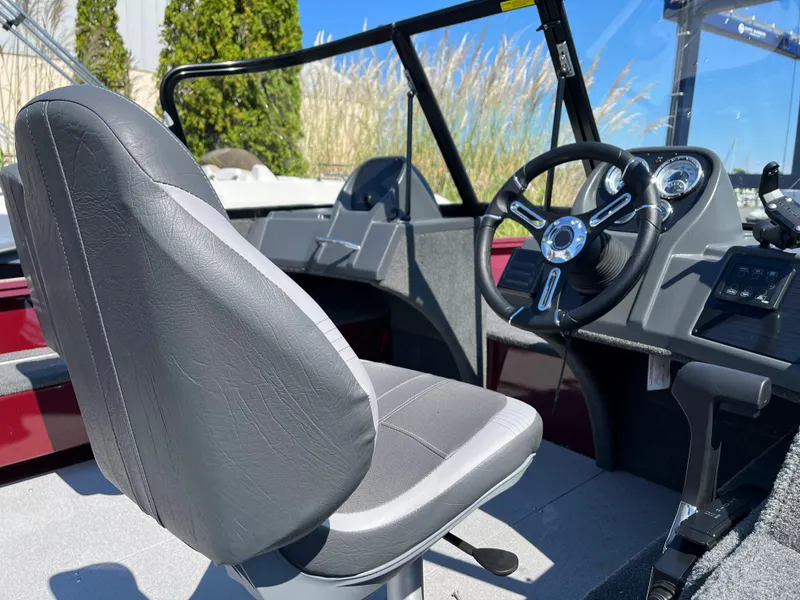 Slide: The Image of 2023 Starcraft Storm 166 DC boat interior with steering wheel and captain's seat. - 10