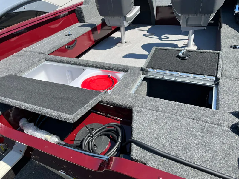 Slide: The Image of 2023 Starcraft Storm 166 DC boat interior with storage compartments and seating. - 12