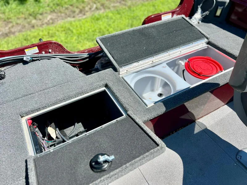 Slide: The Image of 2023 Starcraft Storm 166 SC boat storage compartments with open lids, showcasing interior features. - 13