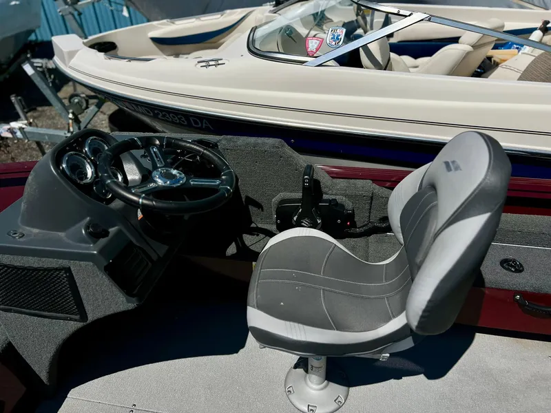 Slide: The Image of 2023 Starcraft Storm 166 SC boat interior with steering wheel and seat. - 17