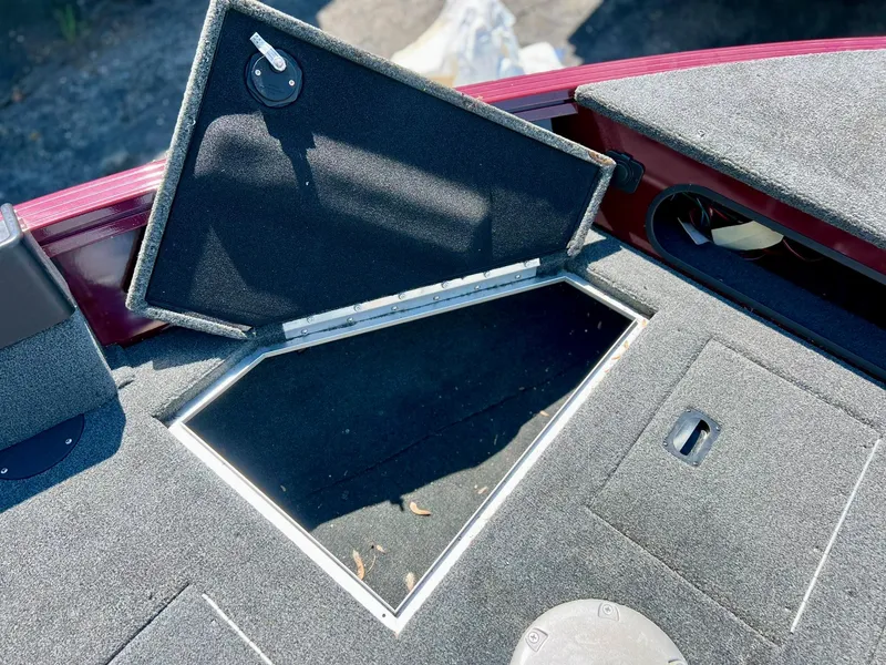 Slide: The Image of 2023 Starcraft Storm 166 SC boat storage compartment with open hatch, showcasing interior space. - 19