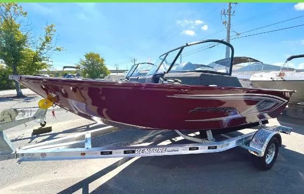 Slide: The Image of 2023 Starcraft Storm 166 DC boat on a trailer in a parking lot. - 2