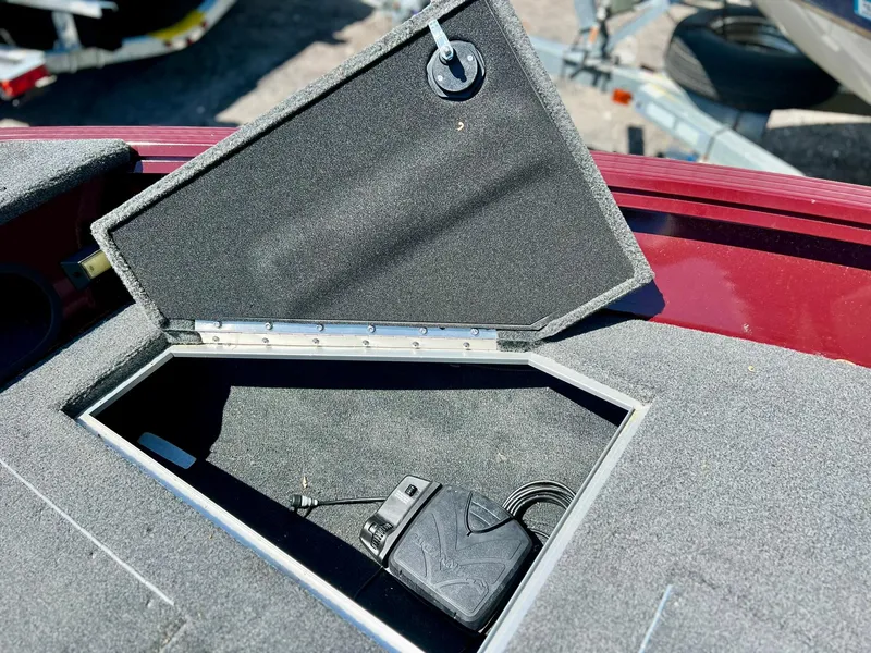 Slide: The Image of Storage compartment in 2023 Starcraft Storm 166 SC boat, featuring a charger inside. - 21