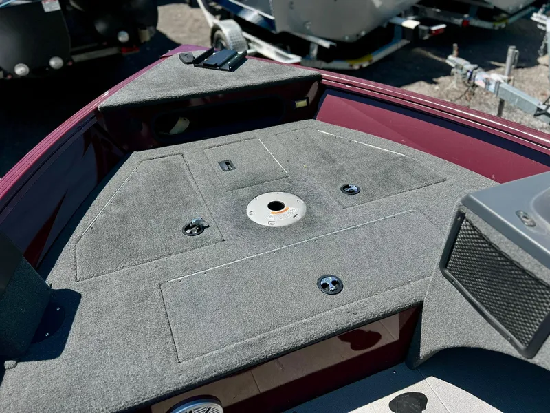 Slide: The Image of 2023 Starcraft Storm 166 SC boat deck with gray carpeting and storage compartments. - 23