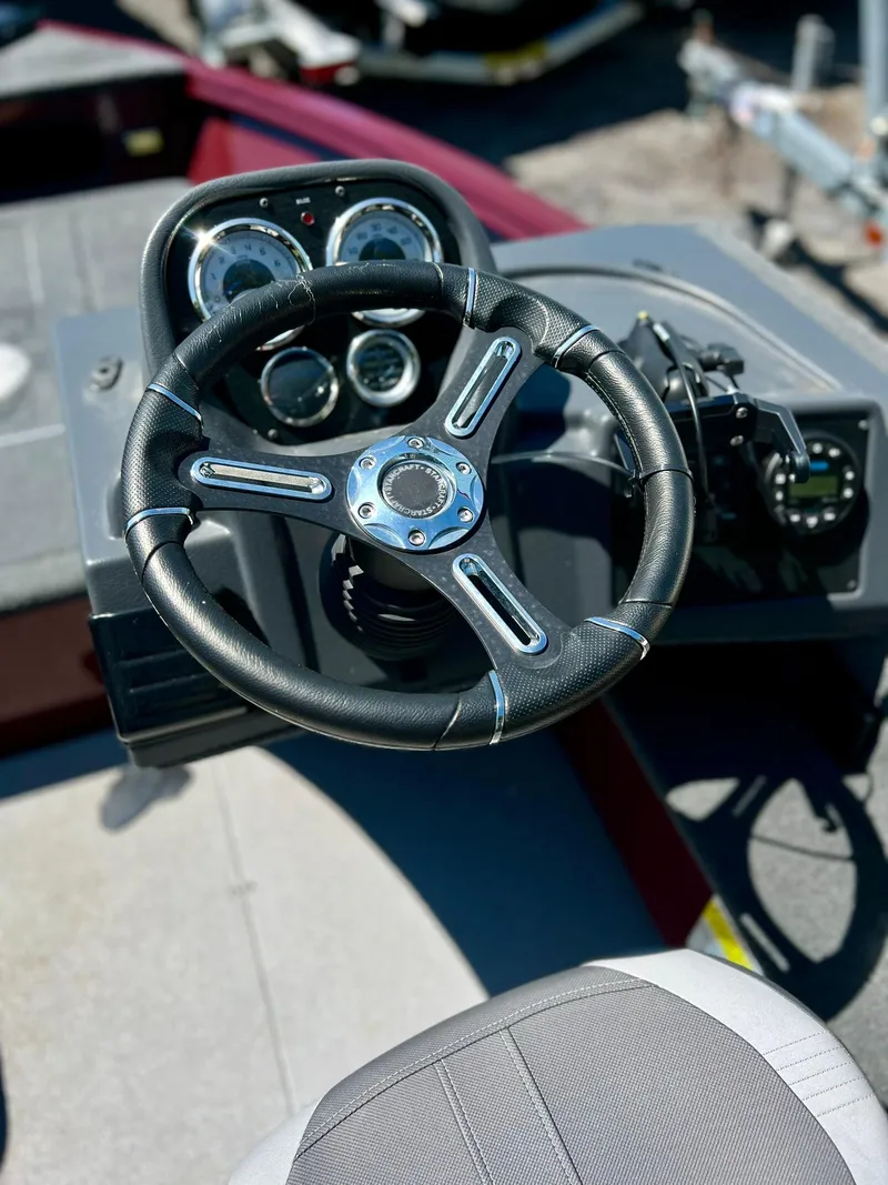 Slide: The Image of 2023 Starcraft Storm 166 SC boat dashboard with steering wheel and gauges. - 25