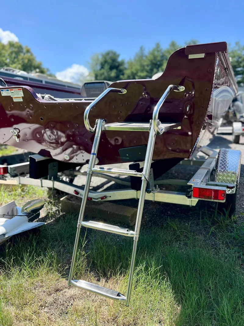 Slide: The Image of 2023 Starcraft Storm 166 SC boat on trailer with ladder, parked on grass. - 26