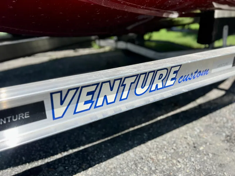 Slide: The Image of Trailer for 2023 Starcraft Storm 166 SC boat, featuring Venture custom branding. - 27
