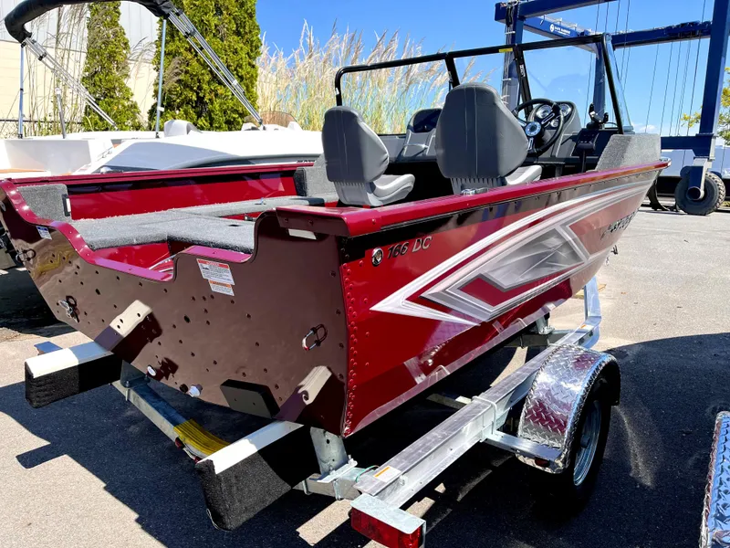 Slide: The Image of 2023 Starcraft Storm 166 DC boat on trailer, red and silver design. - 4