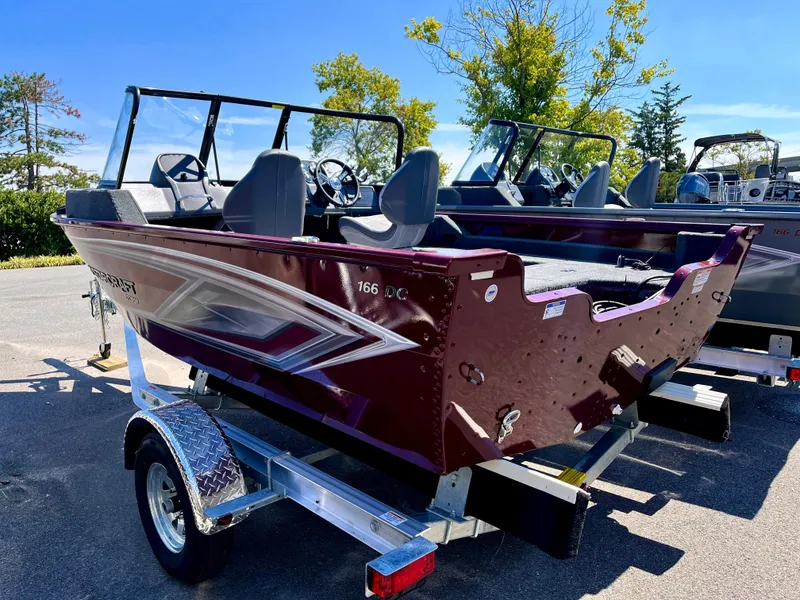 Slide: The Image of 2023 Starcraft Storm 166 DC boat on a trailer in a parking lot. - 6