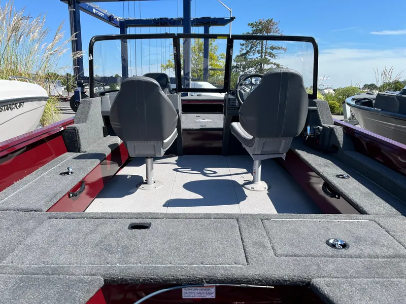Slide: The Image of 2023 Starcraft Storm 166 DC boat interior with dual seats and spacious deck. - 8