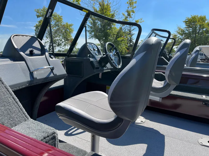 Slide: The Image of 2023 Starcraft Storm 166 DC boat interior with gray seats and steering console. - 9