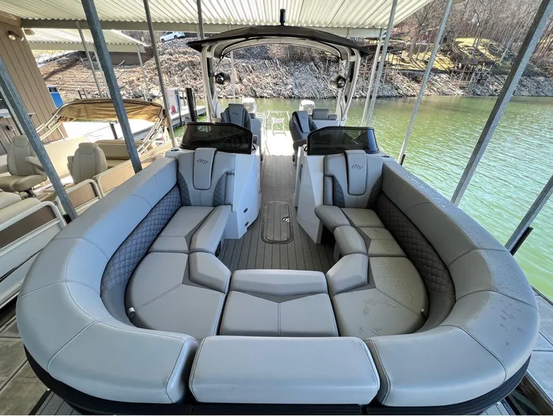 Slide: The Image of 2023 Manitou LX 25 SRW pontoon boat with spacious seating and modern design. - 11