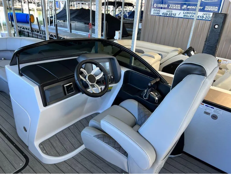 Slide: The Image of 2023 Manitou LX 25 SRW boat interior with steering wheel and seating. - 20