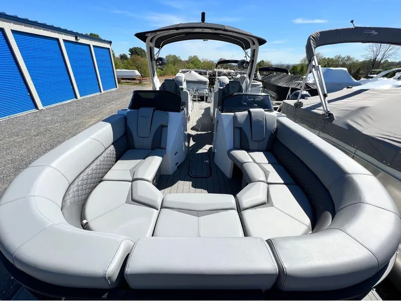 Slide: The Image of 2023 Manitou LX 25 SRW pontoon boat with spacious seating and modern design. - 27