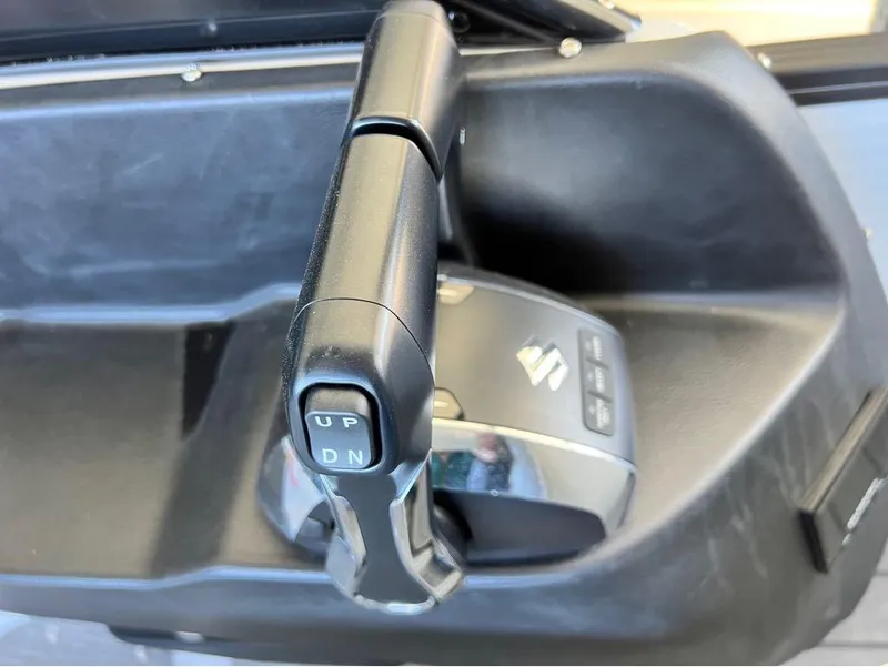 Slide: The Image of 2023 Manitou LX 25 SRW throttle control with Suzuki branding, close-up view. - 36