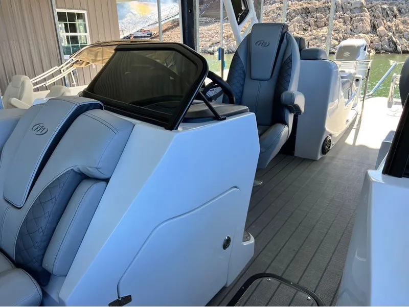 Slide: The Image of 2023 Manitou LX 25 SRW boat interior with luxurious seating and modern design. - 37