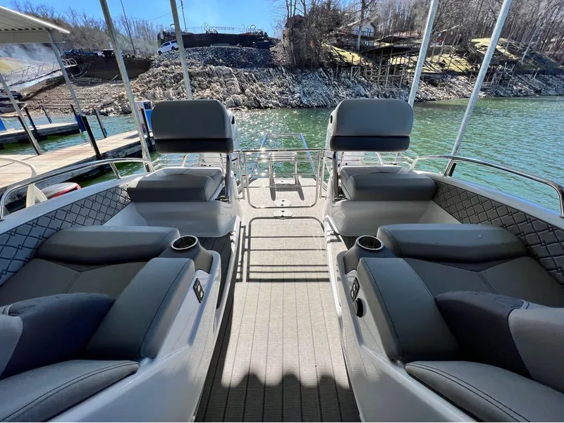 Slide: The Image of 2023 Manitou LX 25 SRW pontoon boat interior with plush seating and cup holders. - 40
