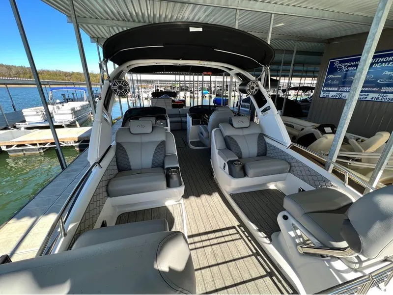 Slide: The Image of 2023 Manitou LX 25 SRW pontoon boat interior at marina dock. - 41