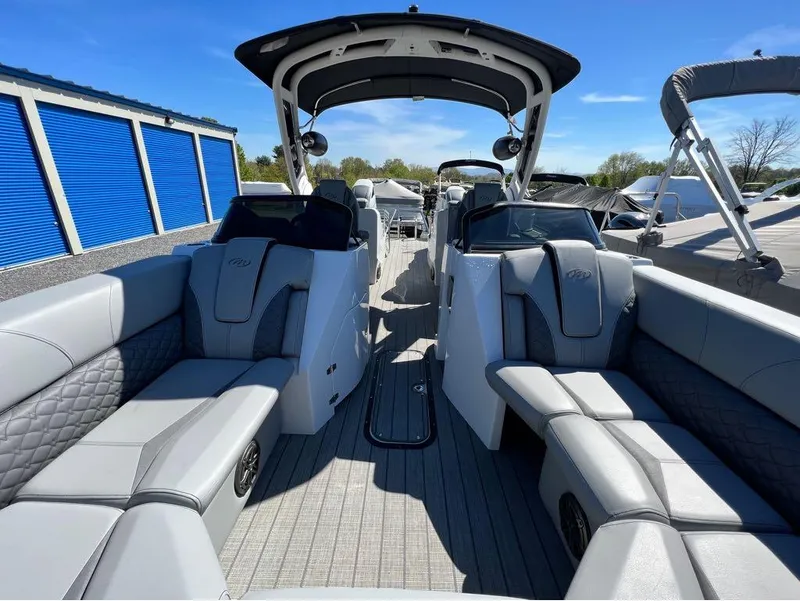 Slide: The Image of 2023 Manitou LX 25 SRW pontoon boat with luxurious seating and modern design. - 5
