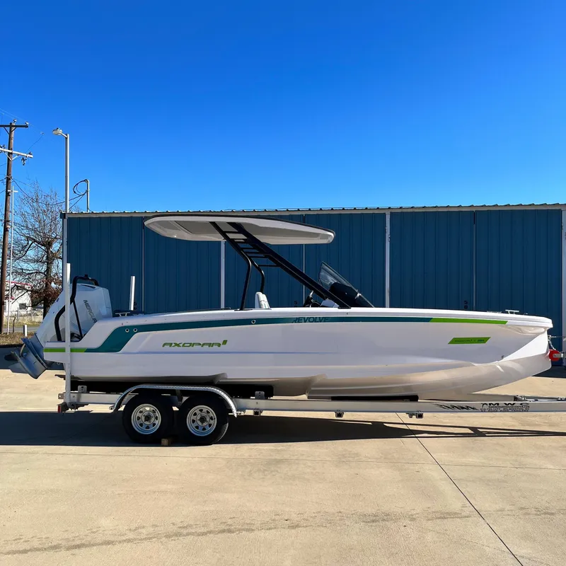 Slide: The Image of 2022 Axopar 22 T-Top x Jobe Revolve boat on calm water at sunset. - 3