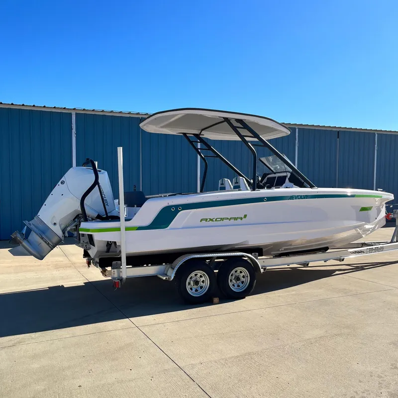 Slide: The Image of 2022 Axopar 22 T-Top x Jobe Revolve boat on calm water at sunset. - 4
