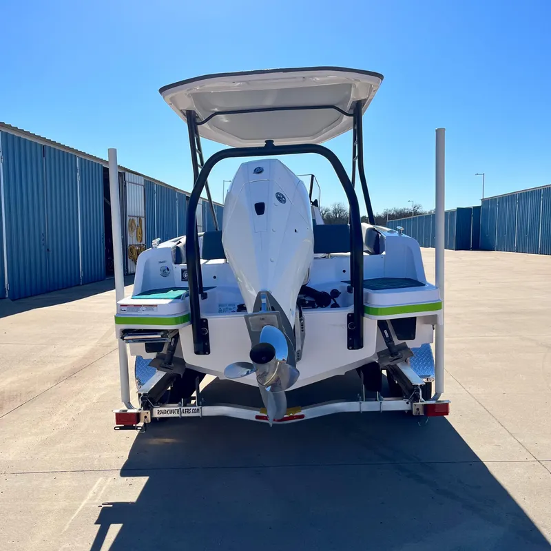 Slide: The Image of 2022 Axopar 22 T-Top x Jobe Revolve boat interior with Mercury engine on a lake. - 5
