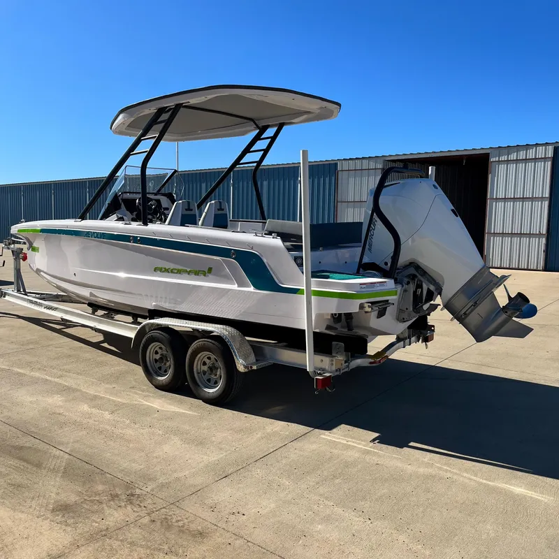 Slide: The Image of 2022 Axopar 22 T-Top x Jobe Revolve boat interior with toilet and sink. - 6