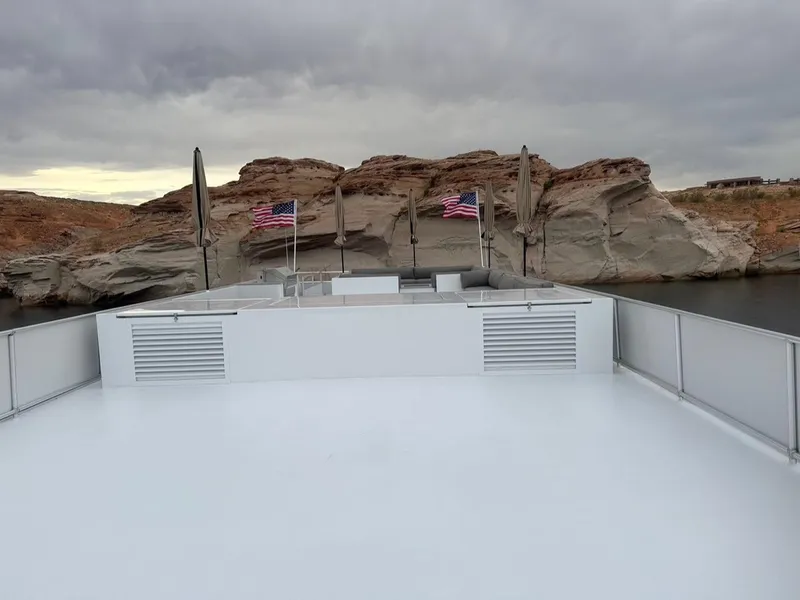 Slide: The Image of ```json
{
  "alt_text": "Adonia Meticulous Share #7 boat with American flags, rocky landscape, cloudy sky, 2023."
}
``` - 19