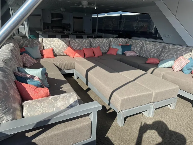 Slide: The Image of Luxurious yacht lounge with beige seating, colorful cushions, and modern decor, Adonia Meticulous Share #7, 2023. - 4