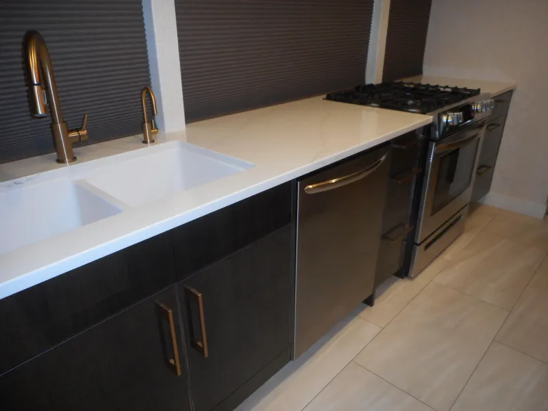 Slide: The Image of Modern kitchen with stainless steel appliances and white countertop. - 37