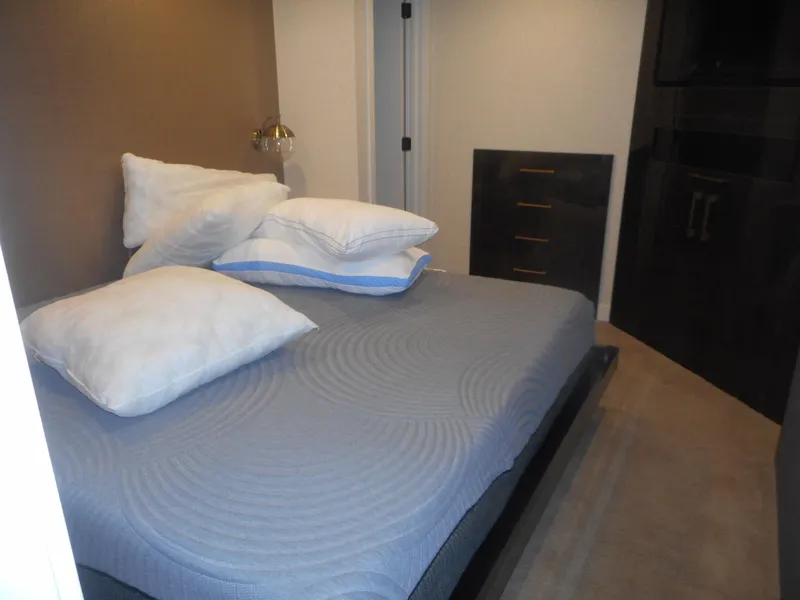 Slide: The Image of Bedroom in Adonia Sojourn Trip #9, 2021, with gray bed and pillows. - 8