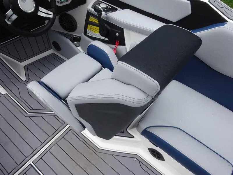 Slide: The Image of 2023 Nautique S23 boat interior with gray and blue seating and modern controls. - 5