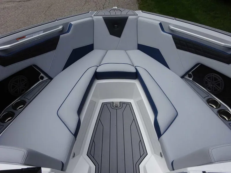 Slide: The Image of 2023 Nautique S23 boat interior with cushioned seating and cup holders. - 8