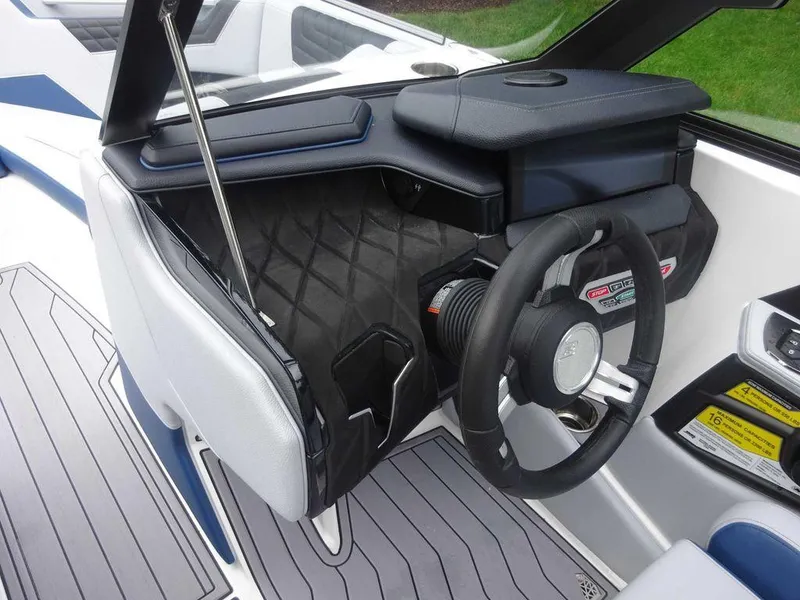 Slide: The Image of 2023 Nautique S23 boat cockpit with steering wheel and dashboard. - 9
