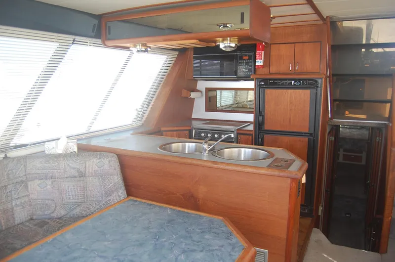 Slide: The Image of Interior of 1992 Bayliner 4588 Pilothouse MY with kitchen and seating area. - 15