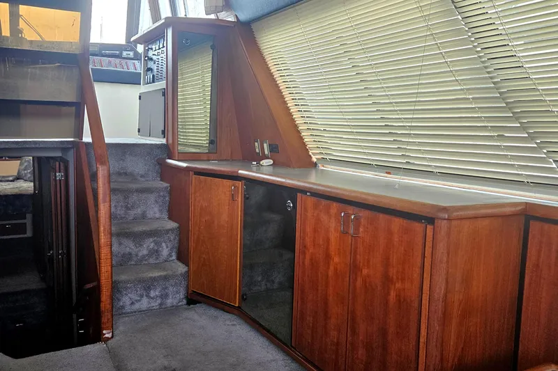 Slide: The Image of Interior of 1992 Bayliner 4588 Pilothouse MY with wooden cabinets and carpeted stairs. - 16