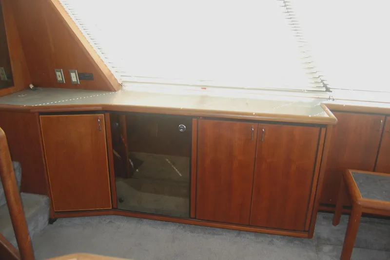 Slide: The Image of 1992 Bayliner 4588 Pilothouse MY interior with wooden cabinets and carpeted flooring. - 18