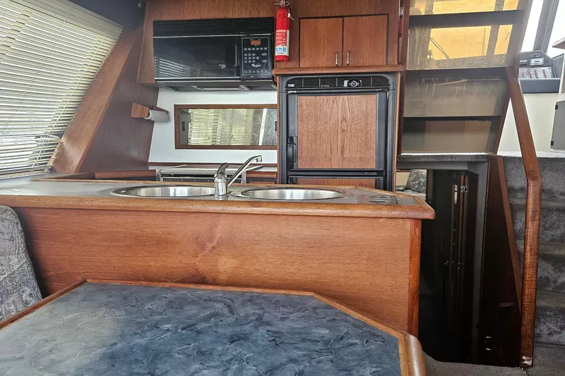 Slide: The Image of Interior of 1992 Bayliner 4588 Pilothouse MY with kitchen and dining area. - 21