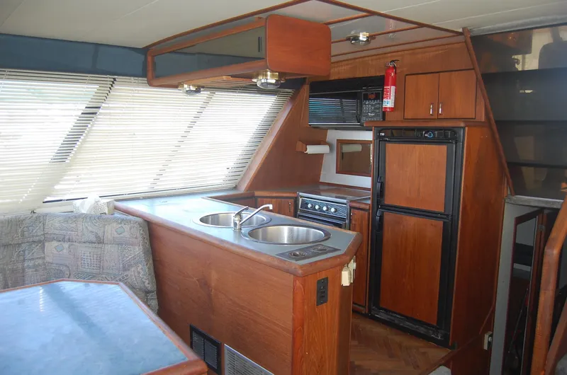 Slide: The Image of 1992 Bayliner 4588 Pilothouse MY interior with kitchen and seating area. - 22