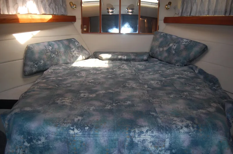Slide: The Image of Cozy cabin interior of 1992 Bayliner 4588 Pilothouse MY with patterned bedding. - 29