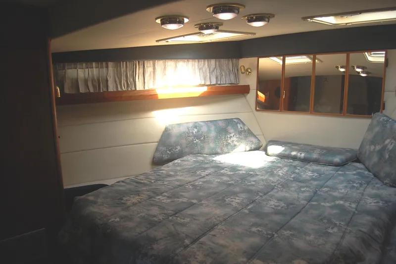 Slide: The Image of 1992 Bayliner 4588 Pilothouse MY bedroom with cozy bed and natural light. - 31