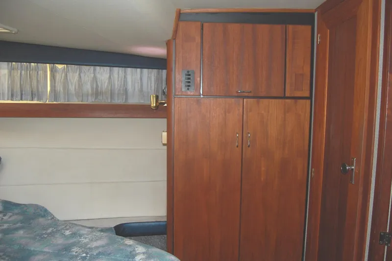 Slide: The Image of 1992 Bayliner 4588 Pilothouse MY interior with wooden cabinets and cozy sleeping area. - 33