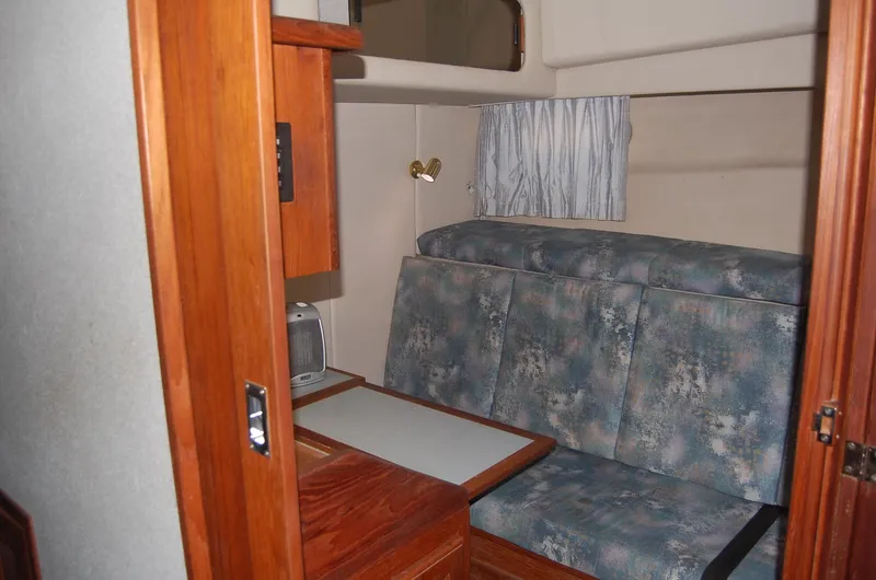 Slide: The Image of 1992 Bayliner 4588 Pilothouse MY interior with cushioned seating and wooden cabinetry. - 38
