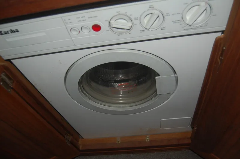 Slide: The Image of Washing machine inside 1992 Bayliner 4588 Pilothouse MY, surrounded by wooden cabinetry. - 41