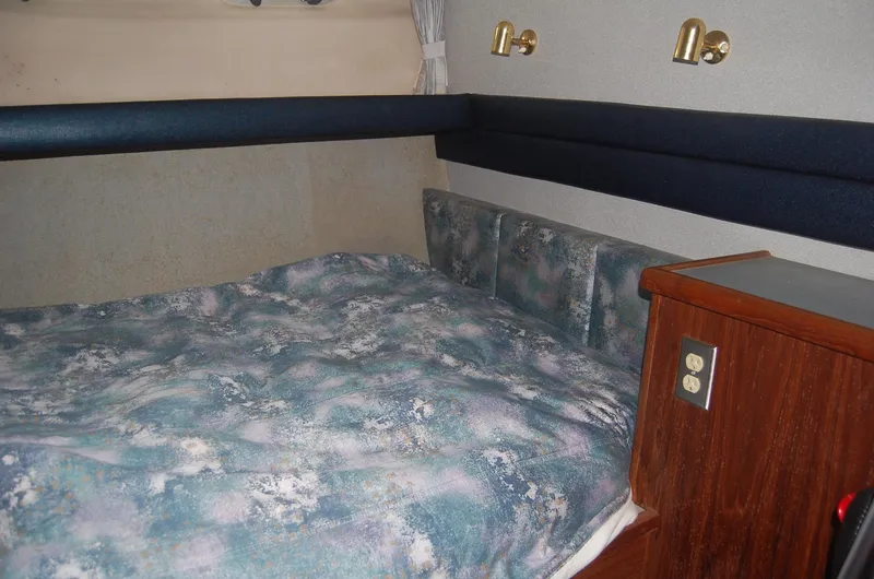 Slide: The Image of Cozy cabin interior of 1992 Bayliner 4588 Pilothouse MY with patterned bedding and wood accents. - 42
