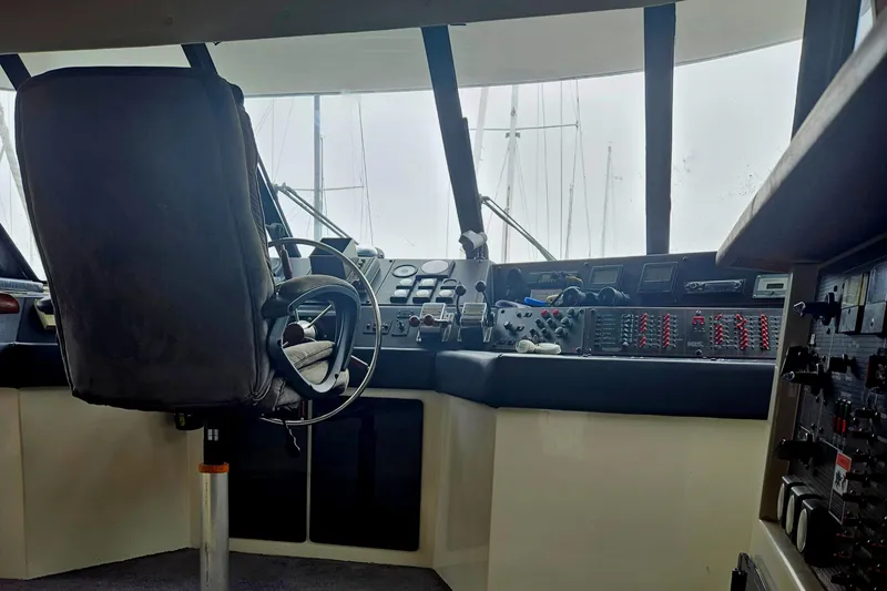 Slide: The Image of Interior view of 1992 Bayliner 4588 Pilothouse MY helm with steering wheel and control panels. - 48