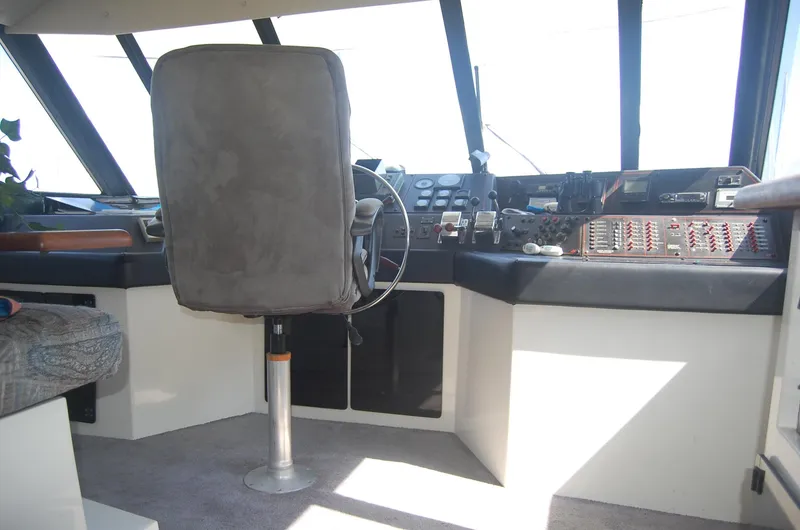 Slide: The Image of 1992 Bayliner 4588 Pilothouse MY interior with steering wheel and control panel. - 49